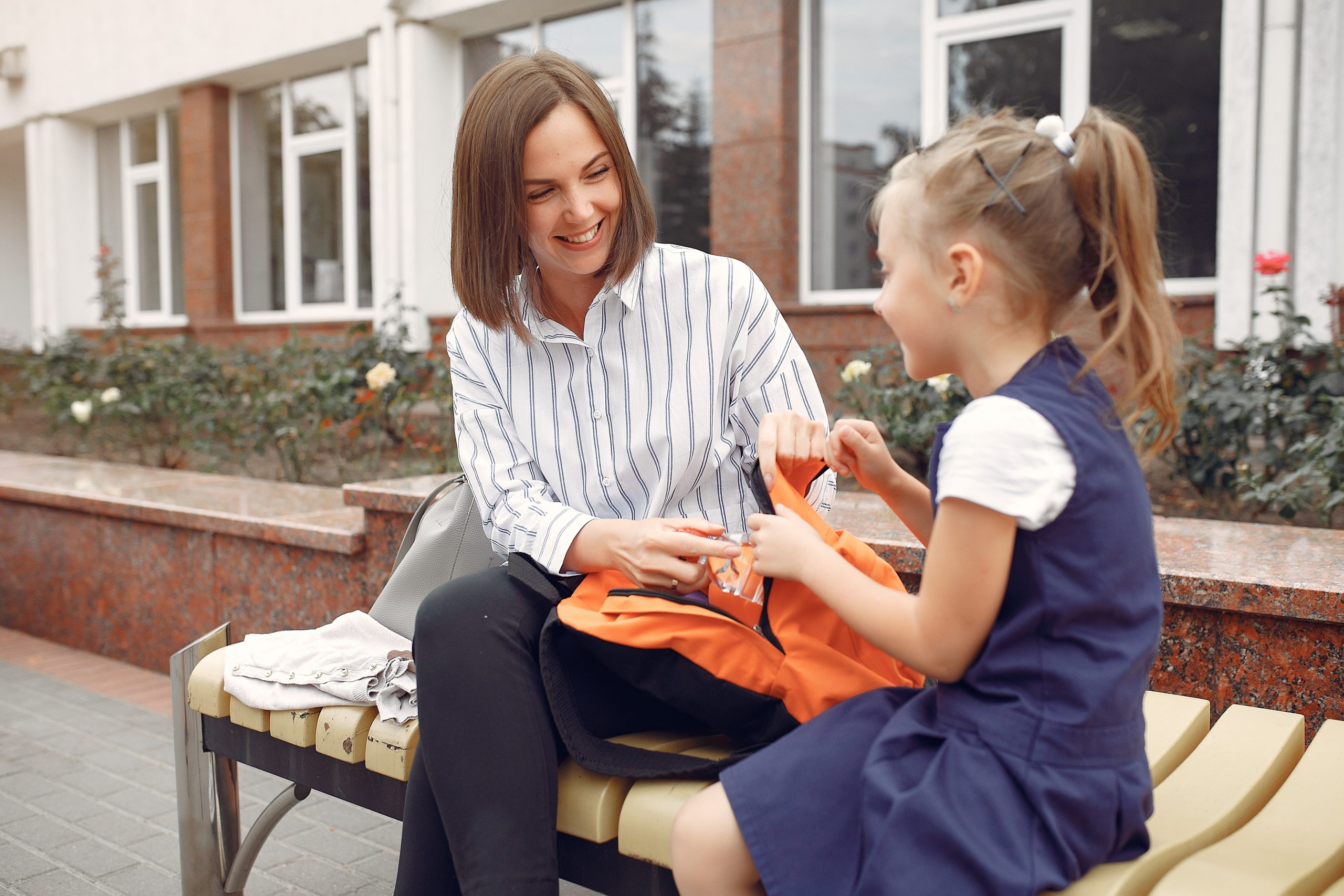 mother prepare little daughter to school